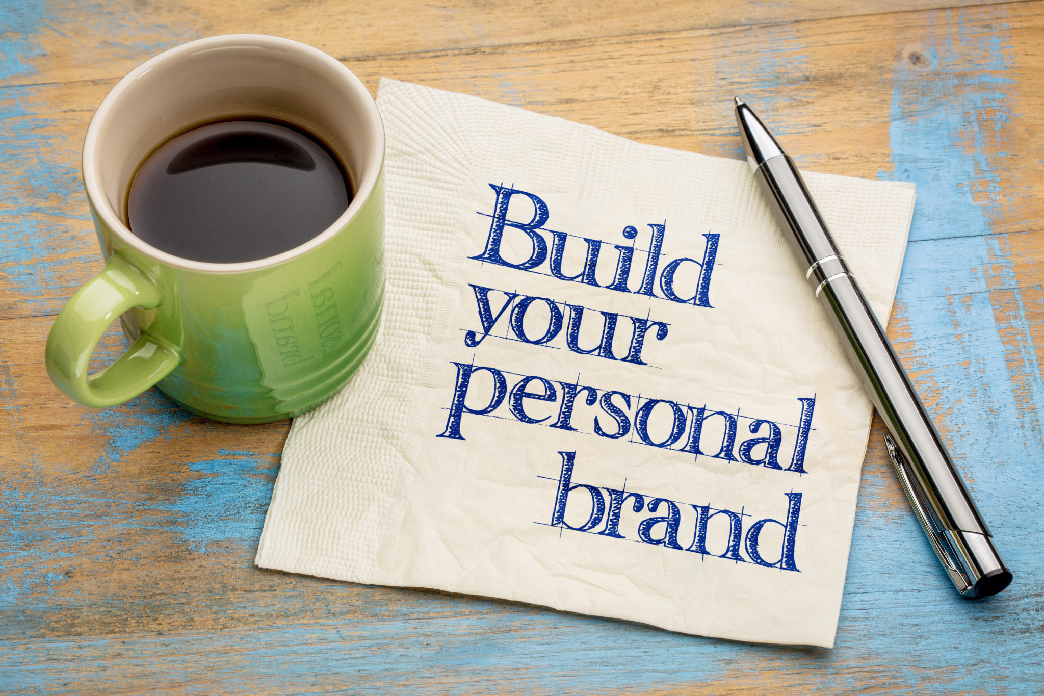 Build your personal brand advice - handwriting on a napkin with a cup of espresso coffee